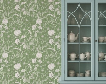 May include: A sage green floral wallpaper with a white outline design of flowers and leaves. A light blue cabinet with glass doors is on the right, displaying white teacups, teapots, and saucers.