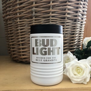 May include: White stainless steel travel mug with a black lid. The mug has a silver Bud Light logo and the text "Brewed for the Best Grandpa".