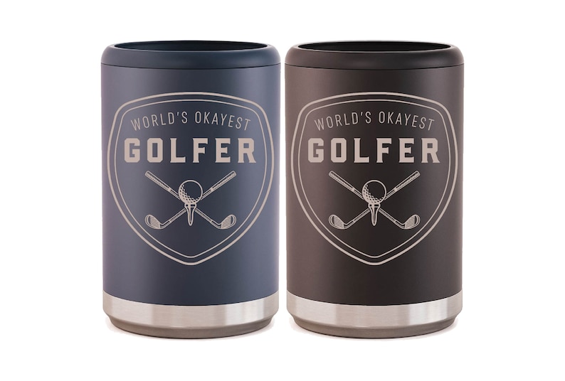 May include: Two stainless steel can coolers in black and blue. Both coolers feature a white graphic of crossed golf clubs and a golf ball with the text "World's Okayest Golfer".