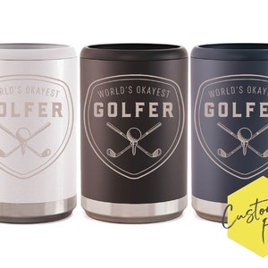 May include: Three insulated can coolers in white, black and blue. Each cooler features a graphic of crossed golf clubs and a golf ball with the text "World's Okayest Golfer".