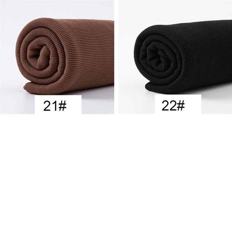 May include: Two rolls of fabric, one in a rich brown and the other in black. The brown fabric is labeled "21#" and the black fabric is labeled "22#". Both rolls are tightly wound, showcasing the ribbed texture of the material.