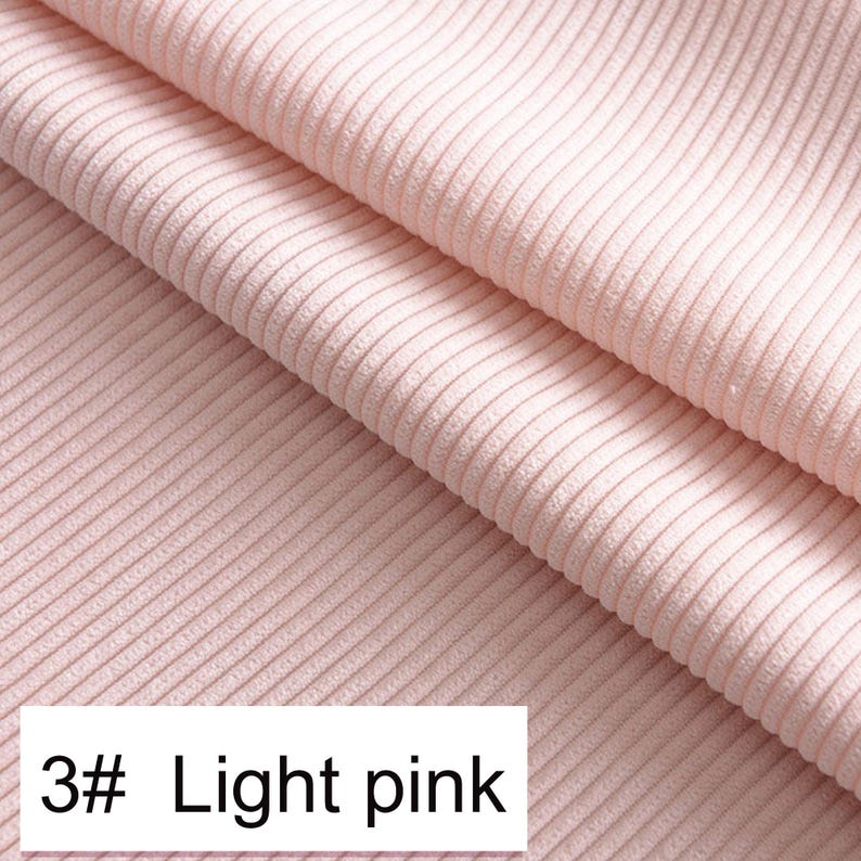 May include: A light pink fabric featuring a distinct vertical ribbed texture. The material is folded to show depth and dimension. A white rectangular label in the bottom left corner displays the black text 3# Light pink, identifying the color.