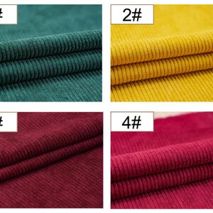 May include: Four fabric swatches of corduroy in different colors: dark green, yellow, burgundy, and red. The swatches are folded in half and labeled with numbers 1 through 4.