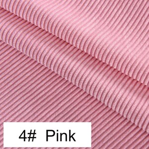 May include: A light pink corduroy fabric featuring a distinct vertical ribbed texture with parallel lines running across the surface. A white rectangular label is positioned at the bottom left corner with the black printed text 4# Pink.