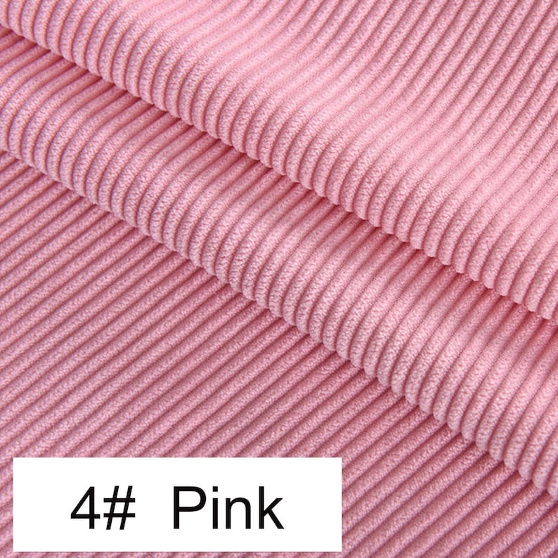 May include: A light pink corduroy fabric featuring a distinct vertical ribbed texture with parallel lines running across the surface. A white rectangular label is positioned at the bottom left corner with the black printed text 4# Pink.