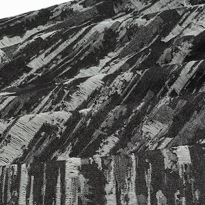 May include: Black and white fabric with a textured, woven pattern. The fabric has a slightly raised, striped design.