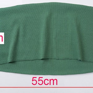 May include: A green fabric item, approximately 22 inches wide and 8 inches high. The fabric has a ribbed texture. The item is displayed on a white background.
