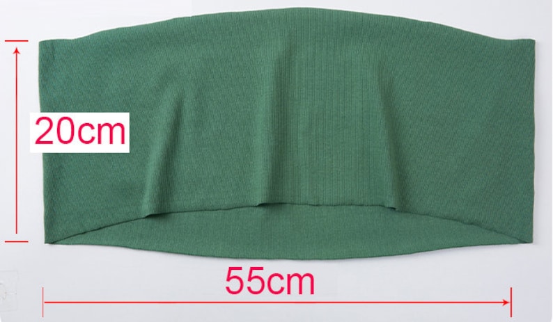 May include: A green fabric item, approximately 22 inches wide and 8 inches high. The fabric has a ribbed texture. The item is displayed on a white background.