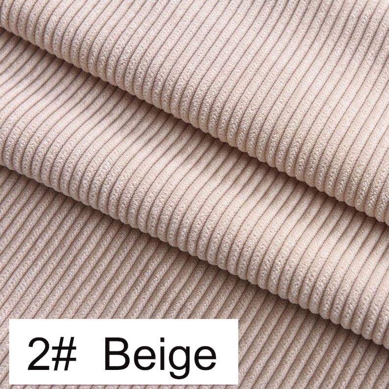 May include: A beige corduroy fabric featuring a distinct vertical ribbed texture with parallel lines running across the surface. A white rectangular label in the bottom left corner displays the black text 2# Beige, identifying the color.