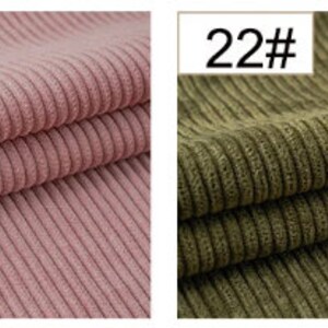 May include: Two fabric swatches, one in a light pink color and the other in a dark green color. Both swatches have a corduroy texture with vertical ribs.