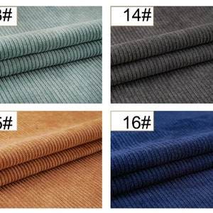 May include: Four fabric swatches in different colors: light blue, gray, brown, and dark blue. Each swatch has a ribbed texture.