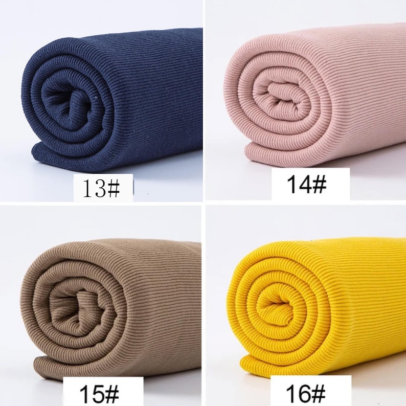 May include: Four rolls of ribbed fabric in navy blue, pink, tan, and yellow. Each roll is tightly wound, displaying the fabric's texture. The numbers 13#, 14#, 15#, and 16# are printed on the fabric.