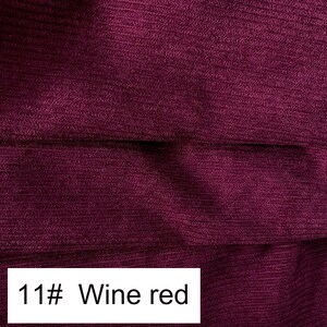 May include: A deep wine red fabric featuring a distinct ribbed texture with horizontal lines running across the surface. A white rectangular label is positioned at the bottom left corner, clearly displaying the black printed text 11# Wine red.