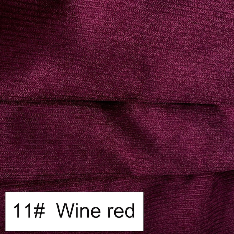May include: A deep wine red fabric featuring a distinct ribbed texture with horizontal lines running across the surface. A white rectangular label is positioned at the bottom left corner, clearly displaying the black printed text 11# Wine red.