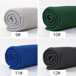 May include: Four rolls of ribbed fabric in various colors. The colors include gray with the text "9#", green with the text "10#", blue with the text "11#", and dark gray with the text "12#". The fabric is tightly rolled.
