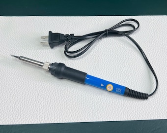 May include: A blue and black soldering iron with a black power cord and a US plug. The iron has a 60W power rating and is labeled "110V".