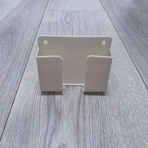 Wall Mounted Phone Holder Stand Self Adhesive with Charging Hole Compatible iPhone Android Smartphone Bedside Organizer Remote Control Stand