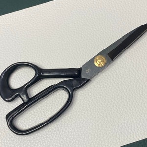 May include: Black fabric shears with a gold accent and the number "8" on the handle.