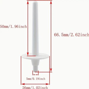 May include: White plastic sewing machine bobbin winder with a 2.62 inch tall post and a 1.96 inch diameter base. The base has a 0.19 inch diameter hole in the center.