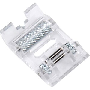 May include: A clear plastic sewing machine foot with a silver metal roller and two silver metal screws.