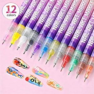 May include: A set of 12 nail art markers in various colors, with the text "NAIL ART MARKER" printed on the purple barrels. The image also shows several painted nail tips with colorful designs, showcasing the markers' versatility.