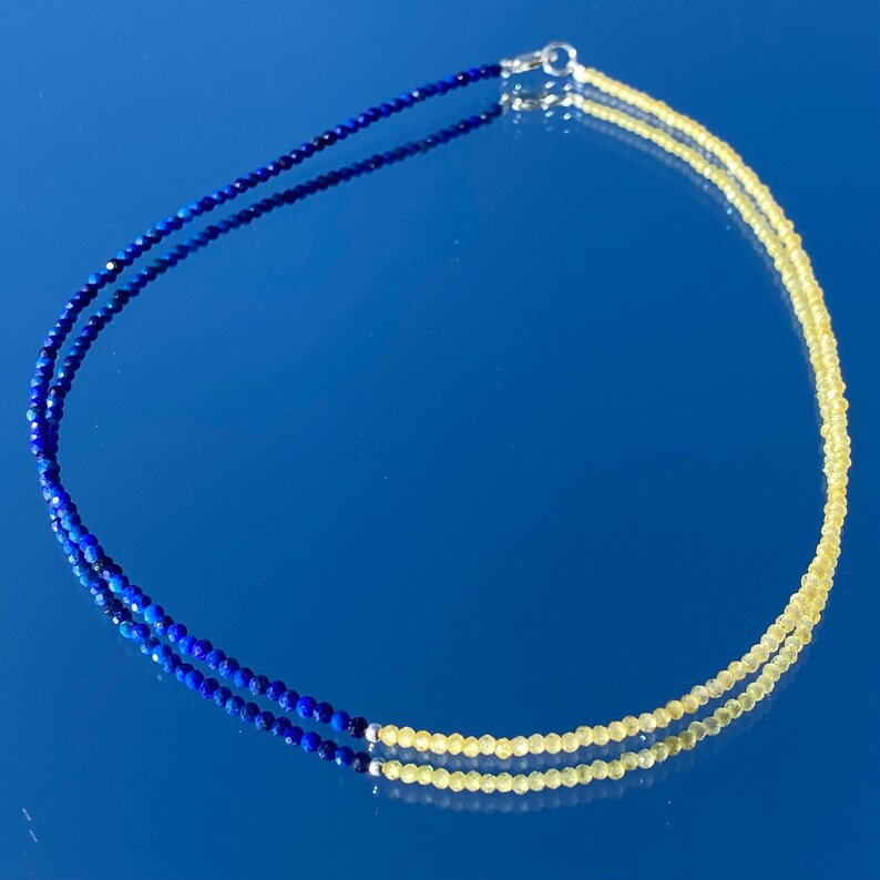 May include: A two-strand necklace with blue lapis lazuli beads on one strand and yellow citrine beads on the other strand.