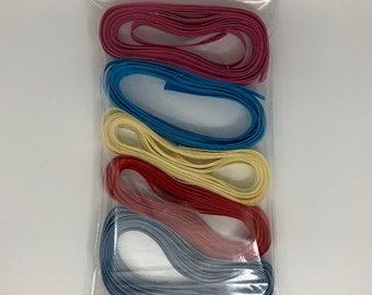 May include: A clear plastic bag containing six rolls of colorful ribbon. The ribbon colors are pink, blue, yellow, red, gray, and light blue.