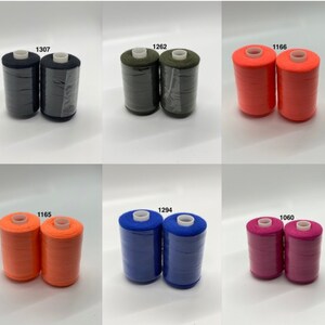 May include: Six spools of thread in various colors, including black, green, orange, blue, and pink. Each spool has a label with a number on it, such as 1307, 1262, 1166, 1165, 1294, and 1060.