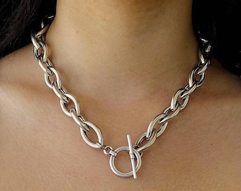 Chunky silver choker with toggle clasp.