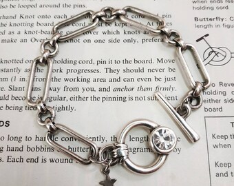 Silver paperclip chain bracelet with a toggle clasp