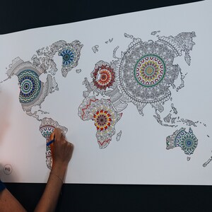 May include: A world map with each continent outlined in black and filled with a colorful mandala design. The continents are North America, South America, Europe, Africa, Asia, and Australia.
