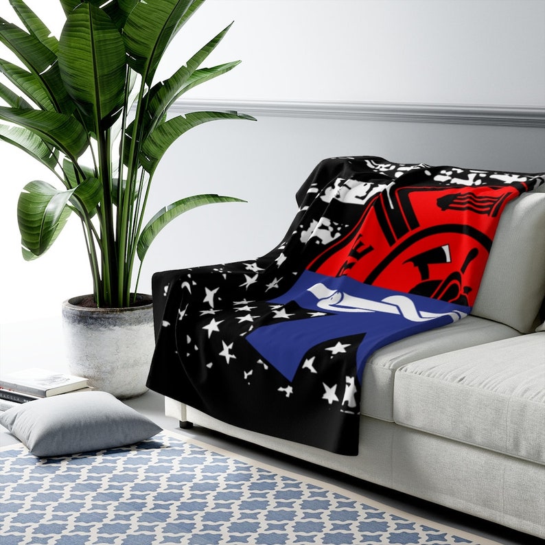 May include: A black, blue, and red fleece throw blanket with a stylized American flag design and a red firefighter's badge with a black axe and the text "Firefighter" in white.