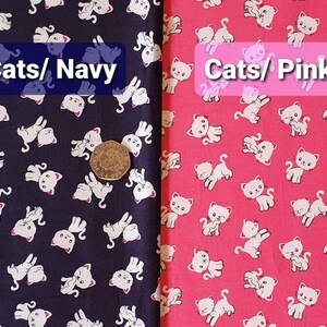 May include: Two fabric swatches with a white cat print on a navy blue background and a pink background. The text "Cats/Navy" is on the navy swatch and "Cats/Pink" is on the pink swatch.