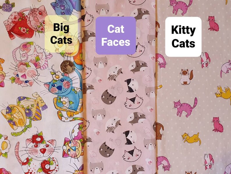 May include: Three fabric swatches with different cat designs. The first swatch features large, colorful cats with floral accents. The second swatch has pink and white cat faces. The third swatch has small, colorful cats on a light beige background. The text on the swatches reads "Big Cats", "Cat Faces", and "Kitty Cats".