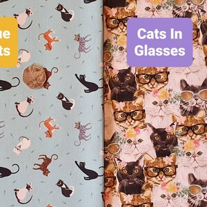 May include: Two fabric swatches with a repeating pattern of cats. The left swatch features blue cats on a light blue background with the text "Blue Cats". The right swatch features cats wearing glasses on a pink background with the text "Cats In Glasses".