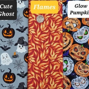 May include: Three fabric swatches with different Halloween themes. The first swatch features a cute ghost and pumpkin design on a light blue background. The second swatch has a red and orange flame pattern. The third swatch has a glow-in-the-dark pumpkin design on a black background. The text on the swatches reads "Cute Ghost", "Flames", and "Glow Pumpkin".