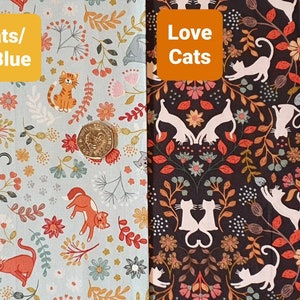 May include: Two fabric swatches with a floral pattern and cats. The left swatch is light blue with the text "Cats/B.Blue" and the right swatch is black with the text "Love Cats".