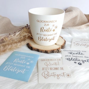 May include: A white ceramic mug with gold lettering that reads "Gl&uuml;ckwunsch zur Rente! Jetzt beginnt die Bl&uuml;tezeit" which translates to "Congratulations on your retirement! Now the bloom time begins".