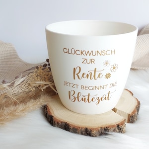 May include: White ceramic mug with gold lettering that reads "Gl&uuml;ckwunsch zur Rente* Jetzt beginnt die Bl&uuml;tezeit".