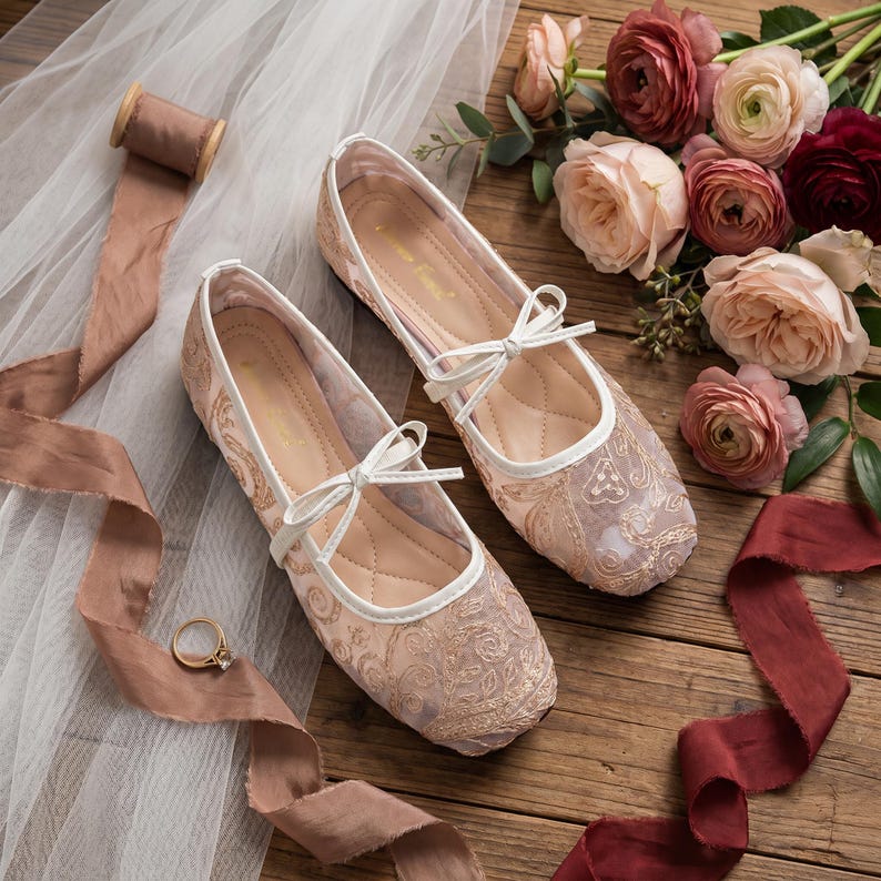 Delicate lace bridal flats with transparent floral mesh and strap styles, minimalist wedding ballet shoes in ivory tones, soft comfortable footwear for bride displayed on neutral fabric background, multiple elegant variations