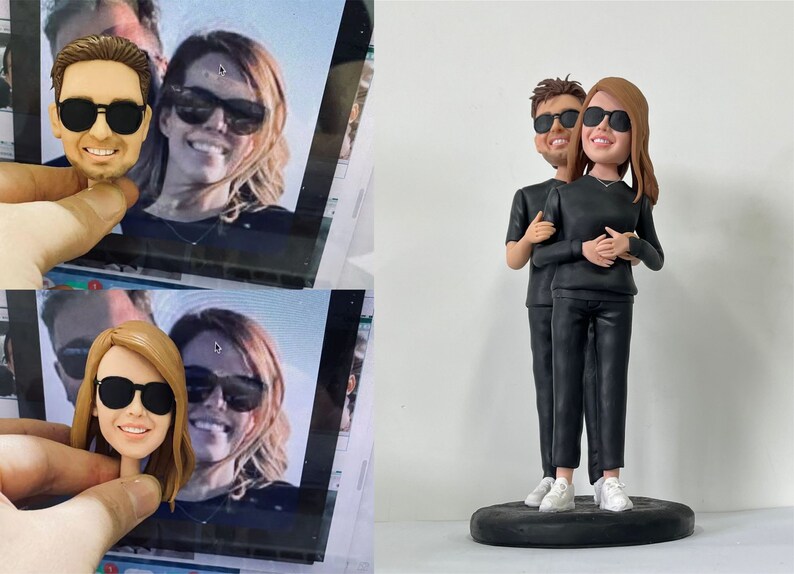 May include: A custom-made figurine of a couple wearing black clothing and sunglasses. The figurine is standing on a black circular base.