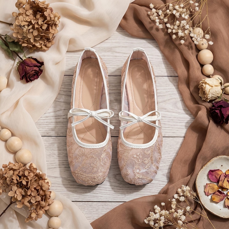 Delicate lace bridal flats with transparent floral mesh and strap styles, minimalist wedding ballet shoes in ivory tones, soft comfortable footwear for bride displayed on neutral fabric background, multiple elegant variations
