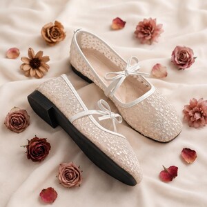 Delicate lace bridal flats with transparent floral mesh and strap styles, minimalist wedding ballet shoes in ivory tones, soft comfortable footwear for bride displayed on neutral fabric background, multiple elegant variations