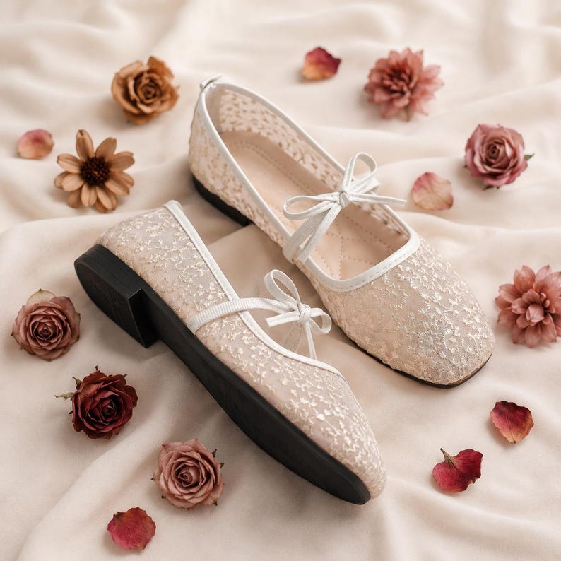 Delicate lace bridal flats with transparent floral mesh and strap styles, minimalist wedding ballet shoes in ivory tones, soft comfortable footwear for bride displayed on neutral fabric background, multiple elegant variations
