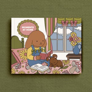 May include: A colourful illustration featuring a cartoon dog reading a book with the text "MOMENTS AT HOME". The dog is wearing blue overalls and sitting on a bed with a floral pattern. A smaller dog is lying down nearby. A window with curtains and flowers is in the background.