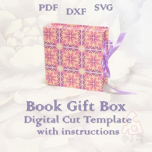 May include: A pink and purple patterned book-shaped gift box with a purple ribbon. The box is labeled "Book Gift Box Digital Cut Template with instructions".