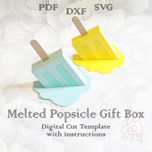 May include: Two papercraft popsicle gift boxes, one light blue and one yellow, with wooden sticks. The boxes are designed to look like melting popsicles. Text on the image reads "Melted Popsicle Gift Box" and "Digital Cut Template with instructions."