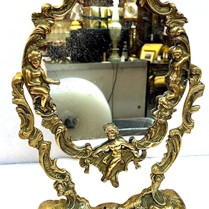 Vintage French Brass Swivel Standing Makeup Mirror with Cherubs and Shell Motifs Purchased During a Recent Trip to Paris, Great Condition