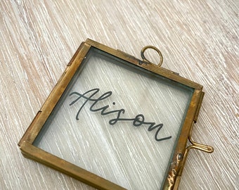 Hand written brass frame name cards