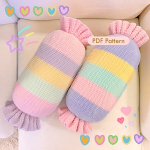 May include: Two handmade, candy-shaped pillows. Each pillow features a striped design in pastel colors: pink, purple, yellow, and green. The ends are ruffled and a lighter shade of pink and purple. The text "PDF Pattern" is visible.